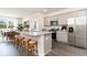 Open kitchen features granite countertops, stainless appliances, and seating, seamlessly connecting to the dining area at 882 Farmers Passage Loop, Loris, SC 29569