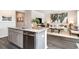Open kitchen with granite counters, stainless steel appliances, and island seating that flows into the living room at 882 Farmers Passage Loop, Loris, SC 29569