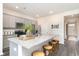 Kitchen island with speckled granite countertops, gray cabinets, seating for four, and modern appliances at 882 Farmers Passage Loop, Loris, SC 29569