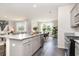 Bright open-concept kitchen and dining area showcasing granite counters and stainless steel appliances at 882 Farmers Passage Loop, Loris, SC 29569