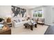 Bright living room featuring a white sofa, stylish decor, and a large window providing ample natural light at 882 Farmers Passage Loop, Loris, SC 29569