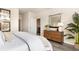 Modern main bedroom with a view into the bathroom and stylish dresser with an elegant mirror and decor at 882 Farmers Passage Loop, Loris, SC 29569