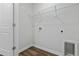 Laundry room with white walls, wire shelving, and vinyl plank flooring at 977 Cherrystone Loop, Conway, SC 29526