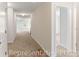 Hallway featuring carpet, white trim, and doors leading to other rooms at 981 Cherrystone Loop, Conway, SC 29526