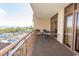 Balcony featuring chairs and table overlooking ocean and pool at 100 North Beach Blvd. # 313, North Myrtle Beach, SC 29582