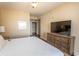 Comfortable bedroom with a large bed and a TV with wood dresser at 100 North Beach Blvd. # 313, North Myrtle Beach, SC 29582