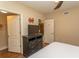 Inviting bedroom featuring wood-look floors, dresser, and easy access to ensuite bathroom and walk-in closet at 100 North Beach Blvd. # 313, North Myrtle Beach, SC 29582