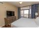 Cozy bedroom featuring a king-size bed, balcony access, and dresser at 100 North Beach Blvd. # 313, North Myrtle Beach, SC 29582