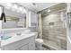 Well-lit bathroom with white vanity and tiled shower stall at 1012 N Waccamaw Dr. # 507, Murrells Inlet, SC 29576