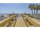 Direct boardwalk access to a sandy beach with people enjoying the ocean at 1012 N Waccamaw Dr. # 507, Murrells Inlet, SC 29576