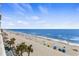 Beautiful beach scene with palm trees and beach umbrellas at 1012 N Waccamaw Dr. # 507, Murrells Inlet, SC 29576
