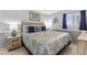 Comfortable bedroom with queen bed, decorative lamps, and bright decor, providing a tranquil retreat at 1012 N Waccamaw Dr. # 507, Murrells Inlet, SC 29576