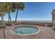 A beachfront hot tub is surrounded by brick pavers, landscaping, and bench seating at 1012 N Waccamaw Dr. # 507, Murrells Inlet, SC 29576