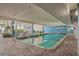 Bright indoor pool area with brick flooring, tables and chairs for lounging at 1012 N Waccamaw Dr. # 507, Murrells Inlet, SC 29576