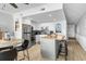 Modern kitchen features white cabinetry, a stainless steel refrigerator, and a butcher block island with bar stool seating at 1012 N Waccamaw Dr. # 507, Murrells Inlet, SC 29576