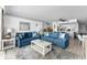 Open-concept living room with stylish blue sofas, open to dining and kitchen areas at 1012 N Waccamaw Dr. # 507, Murrells Inlet, SC 29576