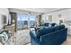 Inviting living room featuring a view of the ocean from the balcony, comfortable blue seating, and bright decor at 1012 N Waccamaw Dr. # 507, Murrells Inlet, SC 29576
