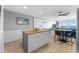 Open living space with kitchen island, dining table, and comfortable seating area overlooking ocean at 1012 N Waccamaw Dr. # 507, Murrells Inlet, SC 29576