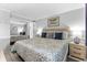 Cozy bedroom featuring stylish bedding and mirrored closet doors at 1012 N Waccamaw Dr. # 507, Murrells Inlet, SC 29576