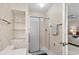 Bathroom with floral wallpaper features a shower with sliding glass doors and glass shelving at 114 Laurelwood Ln., Conway, SC 29526