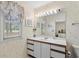 Well-lit bathroom features a white vanity with floral wallpaper and matching window treatment at 114 Laurelwood Ln., Conway, SC 29526