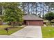 Charming single-story home with a well-manicured lawn and a two-car garage at 114 Laurelwood Ln., Conway, SC 29526