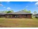 Back exterior of home with patio area overlooking lush yard at 114 Laurelwood Ln., Conway, SC 29526