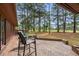 Brick patio with seating area overlooking lush landscaping and golf course at 114 Laurelwood Ln., Conway, SC 29526