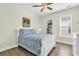 Cozy bedroom with a white bed, blue paisley bedding, hardwood floors, and natural light at 1151 N Blackmoor Dr., Murrells Inlet, SC 29576