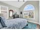Spacious bedroom with large windows, a dark dresser, blue rug, and a comfortable bed at 1151 N Blackmoor Dr., Murrells Inlet, SC 29576
