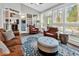 Bright living room boasts a large patterned rug, leather furniture, and access to the outdoor patio at 1151 N Blackmoor Dr., Murrells Inlet, SC 29576