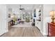 Open-concept living room with large windows, modern furniture, fireplace and hardwood floors at 1151 N Blackmoor Dr., Murrells Inlet, SC 29576