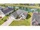 Aerial view of a well-kept home near a serene pond with a fountain, showcasing its desirable neighborhood location at 121 Ashworth Dr., Little River, SC 29566