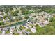 Aerial view of a residential area showcasing charming homes surrounding a tranquil pond with a fountain at 121 Ashworth Dr., Little River, SC 29566
