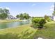 Picturesque backyard view of a serene pond with a fountain feature surrounded by lush landscaping at 121 Ashworth Dr., Little River, SC 29566