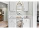 Bright vanity space with white cabinetry, marble countertop, decor, and stylish mirror at 121 Ashworth Dr., Little River, SC 29566