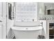 Elegant bathroom showcases soaking tub, decorative tilework, and natural light from block window at 121 Ashworth Dr., Little River, SC 29566