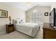 Inviting bedroom with vaulted ceilings, plantation shutters, a ceiling fan and neutral decor at 121 Ashworth Dr., Little River, SC 29566