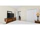 Cozy bedroom with a dresser, television, and access to another room at 121 Ashworth Dr., Little River, SC 29566