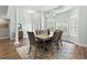 Formal dining room featuring elegant lighting, plantation shutters, and wood floors; perfect for hosting dinner parties at 121 Ashworth Dr., Little River, SC 29566