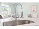 Kitchen sink featuring stainless steel faucet, with view to a living room at 121 Ashworth Dr., Little River, SC 29566
