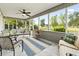 Cozy sunroom with pond views and multiple seating areas at 121 Ashworth Dr., Little River, SC 29566