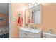 Well-lit bathroom featuring a white vanity with storage, a decorative mirror, and coastal decor at 1500 Cenith Dr. # B402, North Myrtle Beach, SC 29582