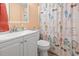 Charming bathroom with white vanity, decorative mirror, and a playful shower curtain showcasing beach-themed designs at 1500 Cenith Dr. # B402, North Myrtle Beach, SC 29582