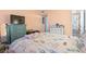 Bright bedroom featuring a beach-themed comforter set, light-colored walls, and a dresser with a television at 1500 Cenith Dr. # B402, North Myrtle Beach, SC 29582