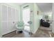 Inviting hallway with a comfortable chair, storage closet, and a glimpse into the cozy living area at 1500 Cenith Dr. # B402, North Myrtle Beach, SC 29582