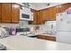 Bright kitchen includes microwave and stove with countertops and cabinets at 1500 Cenith Dr. # B402, North Myrtle Beach, SC 29582