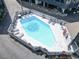 Aerial shot of a pristine pool surrounded by ample lounging space and mature landscaping at 1500 Cenith Dr. # B402, North Myrtle Beach, SC 29582