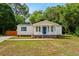 Charming single-story home with a blue front door, blue shutters, and a well-maintained front lawn at 168 Saint Christopher Circle, Pawleys Island, SC 29585