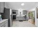 Open kitchen with gray cabinets, stainless steel appliances, and a view to the dining area at 168 Saint Christopher Circle, Pawleys Island, SC 29585